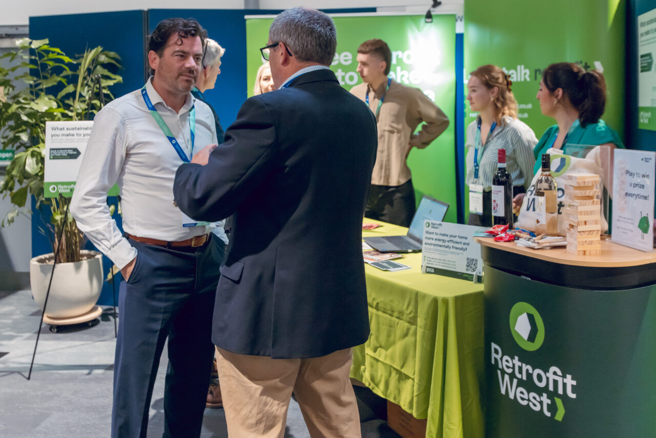 Retrofit West employees talk to people on the exhibition stand. The MD Simon Andrews takes the lead in the foreground. 